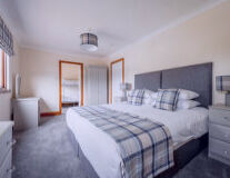 a bedroom with a bed and desk in a hotel room a bedroom with a bed and desk in a hotel room